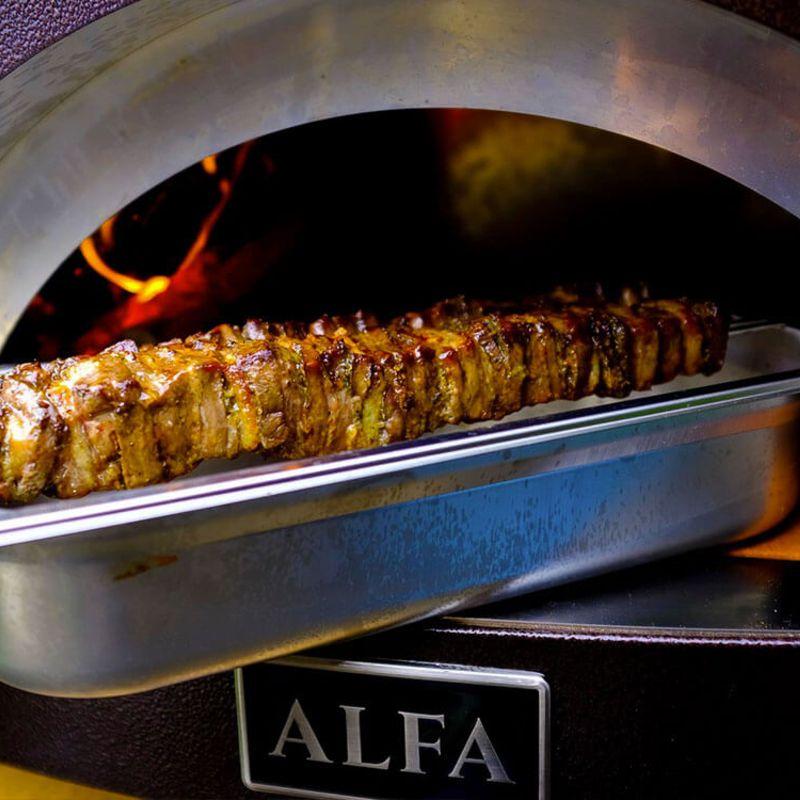 Cooking steak kabobs in a wood-fired oven by Alfa