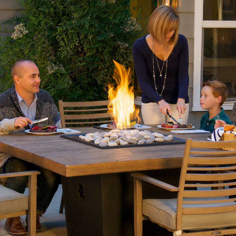 Family eating dinner around a Fire Table