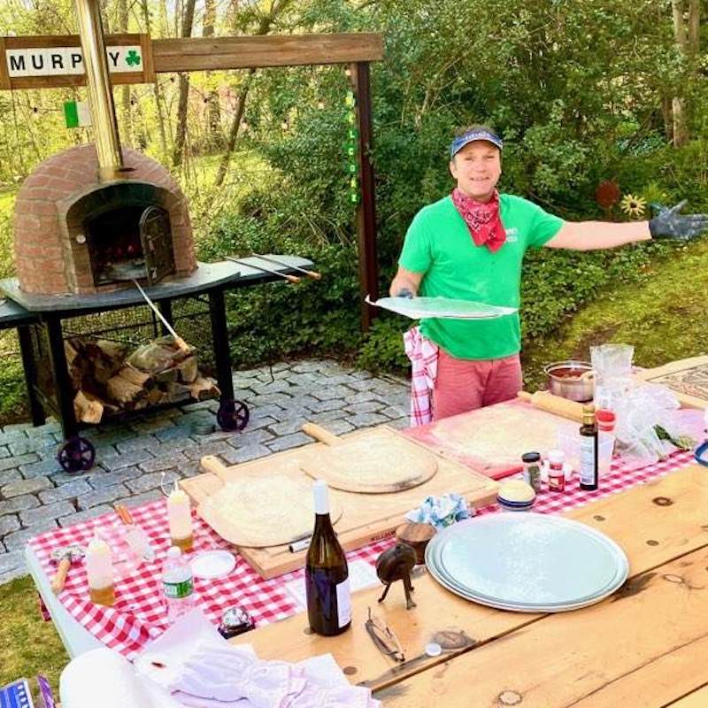 Cooking pizza in a wood burning pizza oven from Portugal