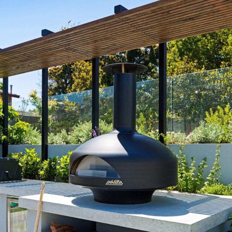 Black Polito Giotto Wood Fired Oven With Bench Stand on an outdoor kitchen counter