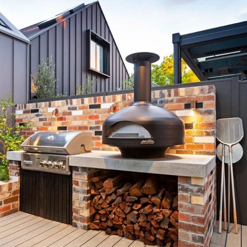 Polito Giotto Wood Fired Oven With Bench Stand next to a grill