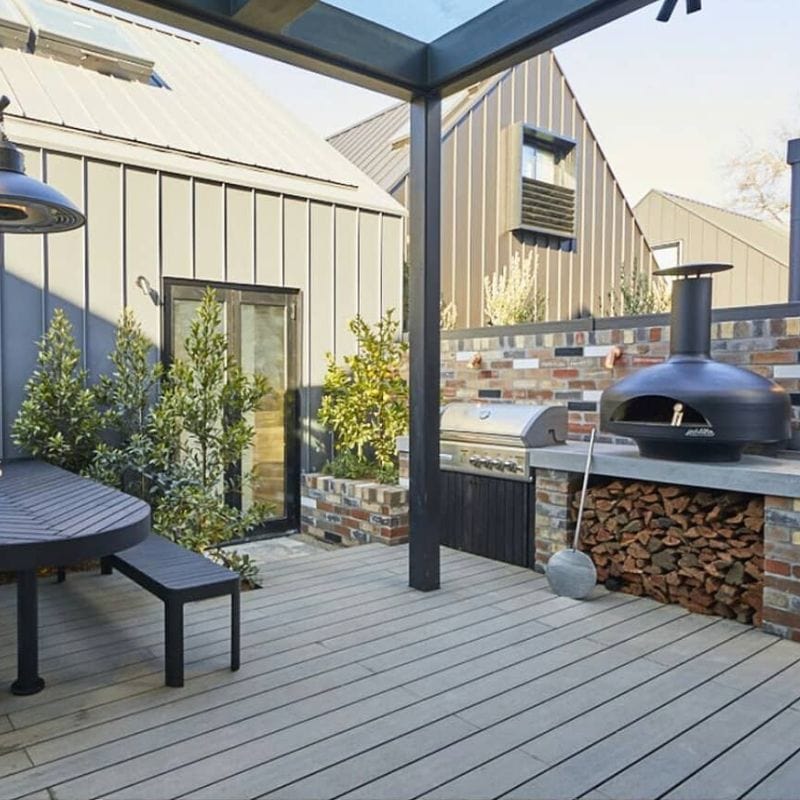 Polito Giotto Wood Fired Oven With Bench Stand in an outdoor kitchen