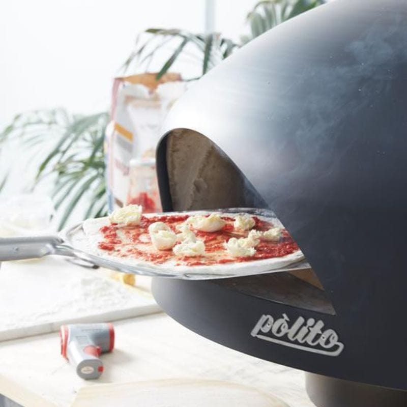 Cooking pizza in a Polito Giotto Wood Fired Oven With Bench Stand