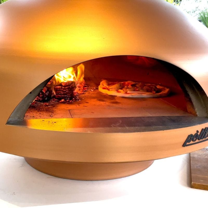 Cooking a pizza in the Polito Giotto Wood Fired Oven With Bench Stand