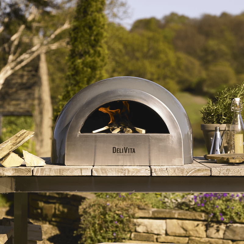 Cooking with a DeliVita pizza oven on a wood countertop
