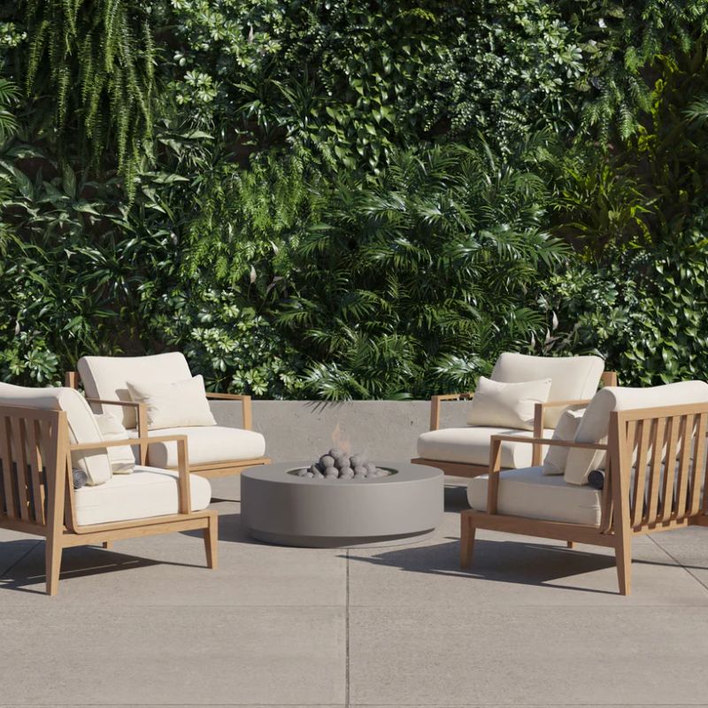 Modern patio with Outer Fire Pit Table and Sofa with lots of greenery backdrop