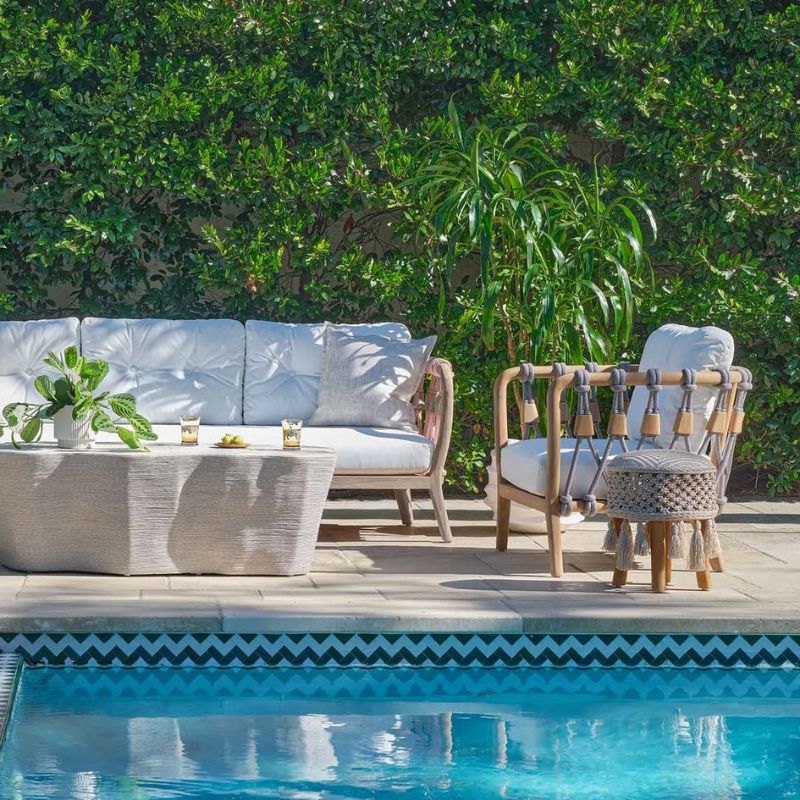 Kingsley Sofa and Kingsley Lounge Chair by the pool and infront of a stone coffee tablel