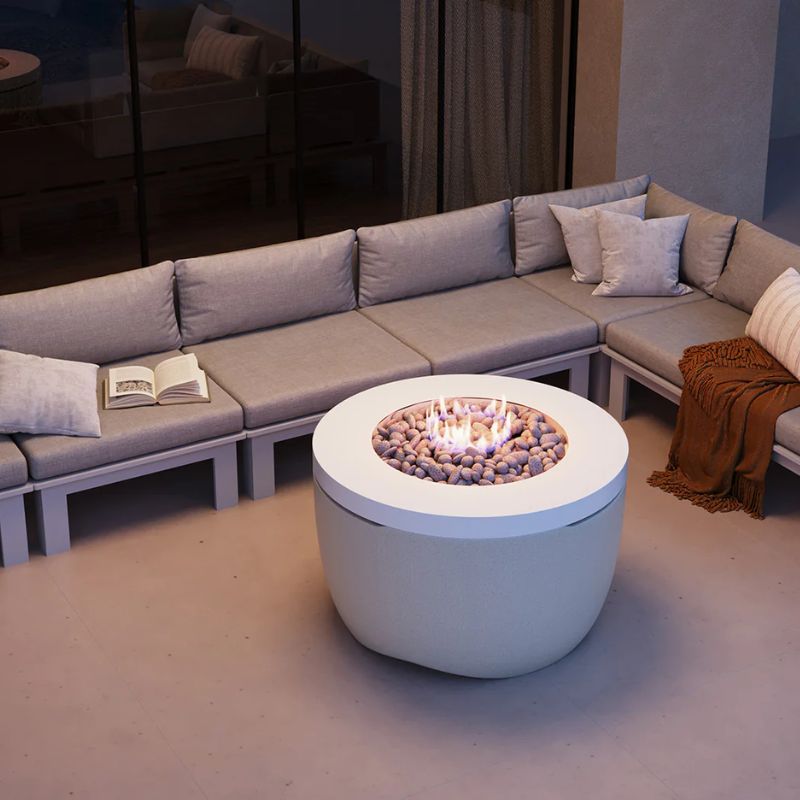 Patio seating around the Ledge Halo Firepit outdoor propane fire table in the color Moonrise