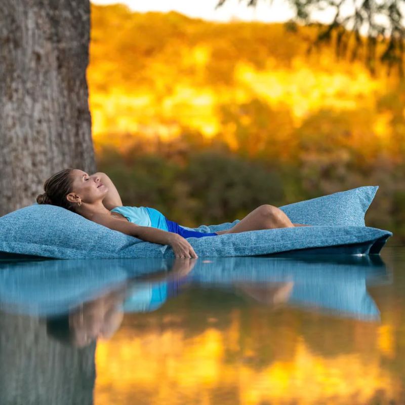Woman sleeping comfortable Ledge Laze pool float made in the USA