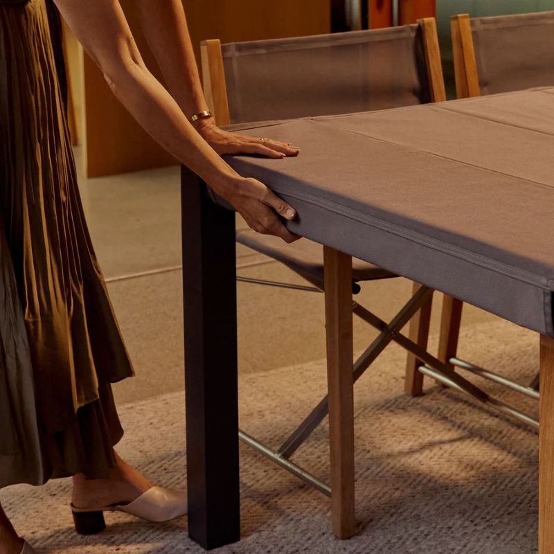 OuterShell cover protecting the outdoor dining table from rain, pollen, and dust