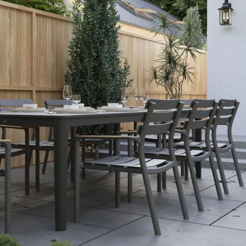 Complete plates and glasses set up nicely on the OuterStone Dining table set with 595 Arm Chairs set on the backyard dining area