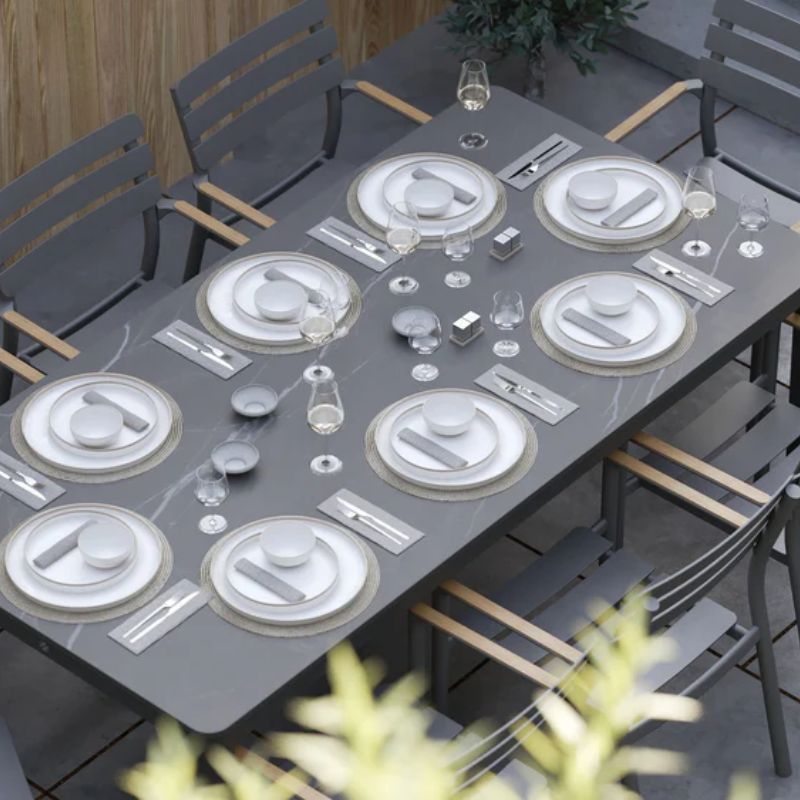 Mineral Gray OuterStone Outdoor Dining table on Garden with complete plate set