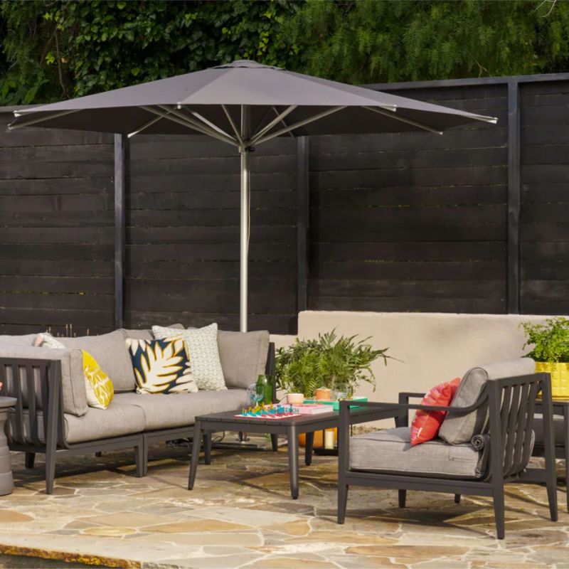 Back patio furniture by the pool with the Outer Charcoal Aluminum Seat set and the round Outer Umbrella