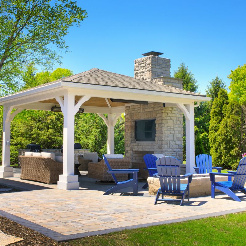 Round Grove Fireplace with long chimney extension next to a pergola