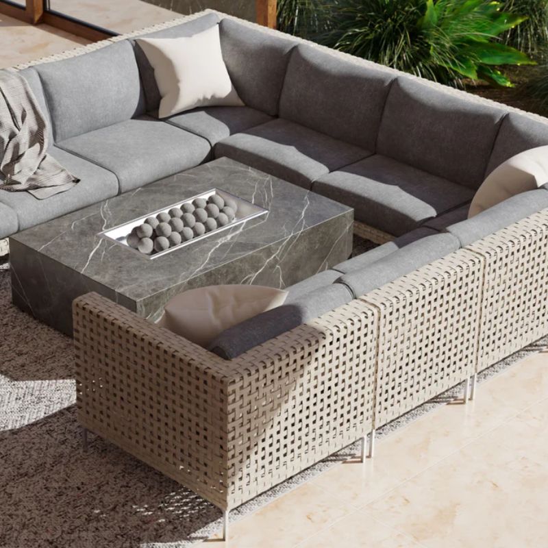 A full 8 seater U Sectional surrounding a firepit table in an outdoor patio