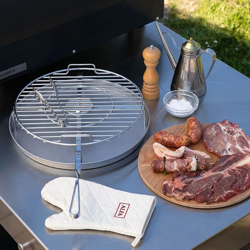 The BBQ500 Rotating Tray and Baking Tray holding charcoal/embers and cooking meat and vegetables