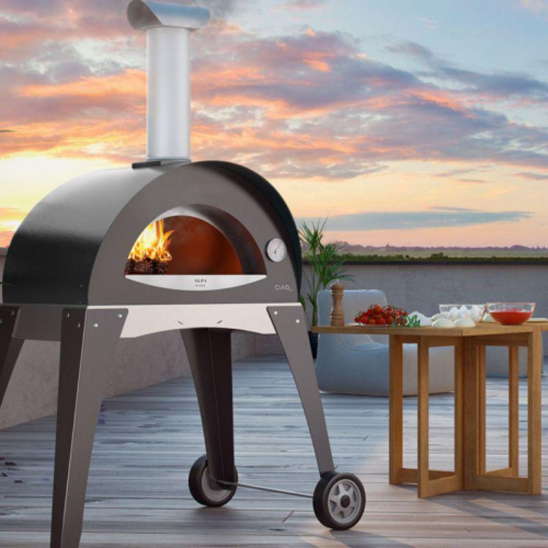 Gray Alfa Ciao Wood Fire Oven on a deck overlooking the sunset